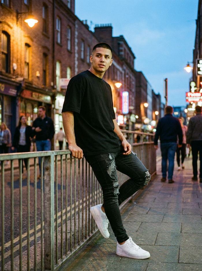 Man wearing skinny distressed ripped jeans on a city street